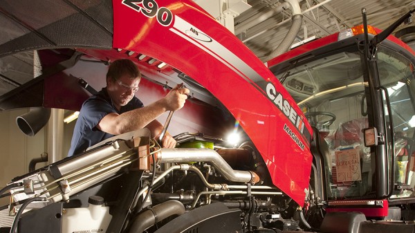 Guy Fixing Tractor